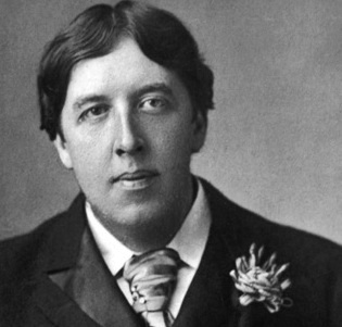 Oscar Wilde with a buttonhole decoration resembling a distinguished order.